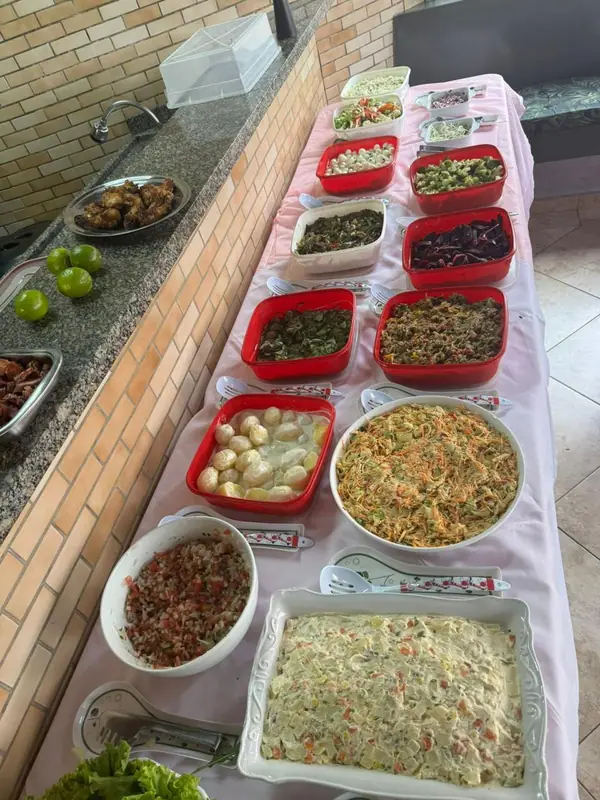 Mesa longa com saladas e acompanhamentos
