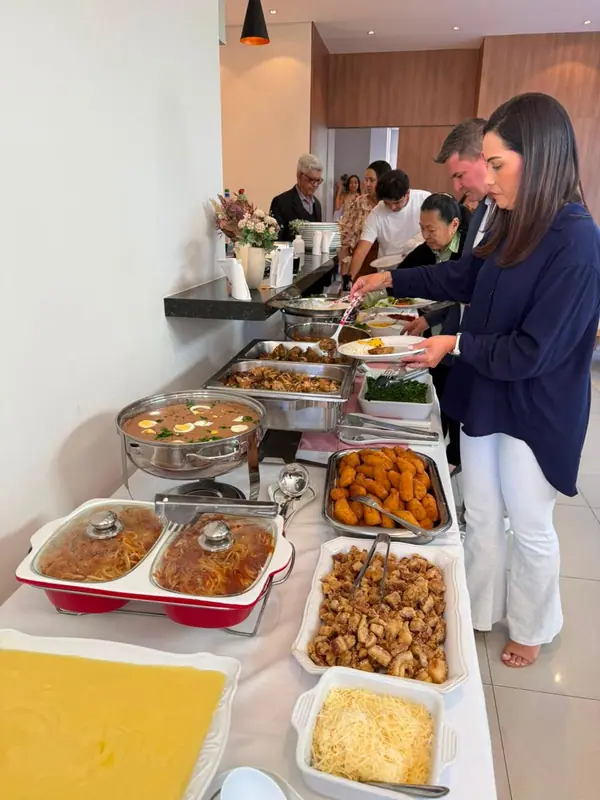 Buffet com pratos quentes sendo servido