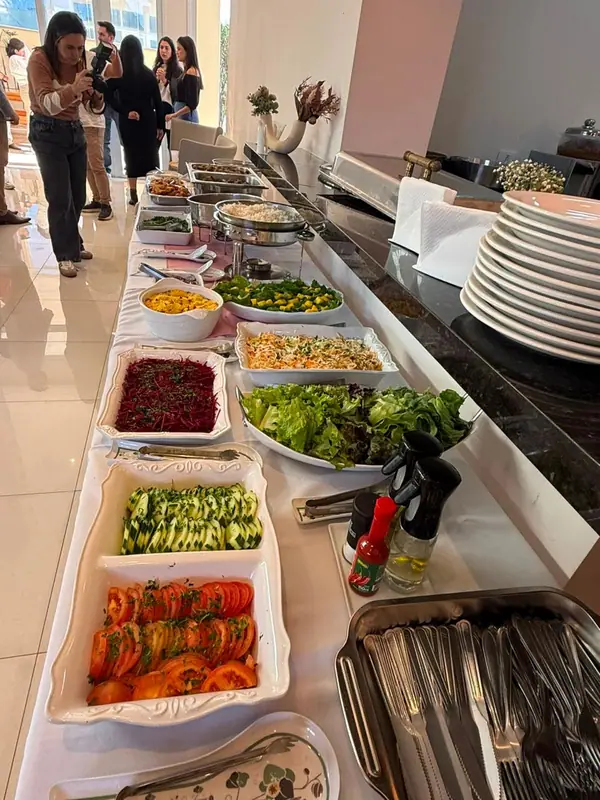 Buffet com saladas e acompanhamentos em mesa longa